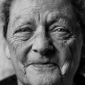 A Glimpse Of Wisdom - Joyful Elderly Woman Wallpaper