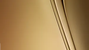 A Gold Background With A Curved Line Wallpaper