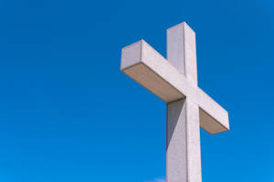 A Golden Cross Symbol Illuminated Against A Beautiful Sky Wallpaper