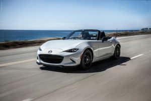 A Gorgeous 2019 Miata Convertible On A Picturesque San Diego Beach. Wallpaper