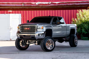 A Gray Truck Parked In Front Of A Red Barn Wallpaper