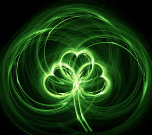 A Green Shamrock On A Black Background Wallpaper