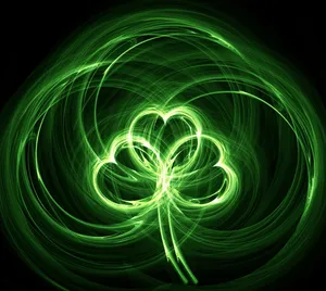 A Green Shamrock On A Black Background Wallpaper