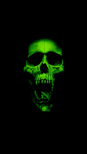 A Green Skull With Teeth On A Black Background Wallpaper