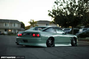 A Green Sports Car Parked On A Street Wallpaper