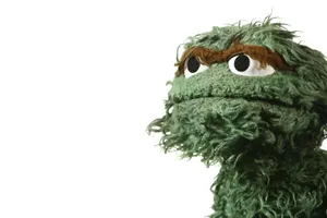 A Green Stuffed Animal With Long Hair Wallpaper