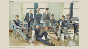 A Group Of Boys In Uniform Sitting On Chairs Wallpaper