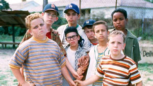 A Group Of Boys Standing Together In A Field Wallpaper