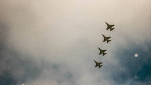 A Group Of Fighter Jets Flying In The Sky Wallpaper