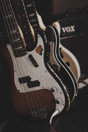 A Group Of Guitars Sitting On A Table Wallpaper