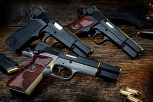 A Group Of Guns On A Wooden Table Wallpaper