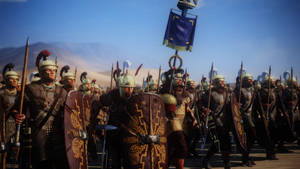 A Group Of Men In Armor And Shields Are Standing In A Desert Wallpaper