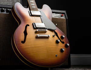 A Guitar Is Sitting On A Black Background Wallpaper