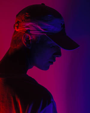 A Guy In A Cap Profile In Ombré Background Wallpaper