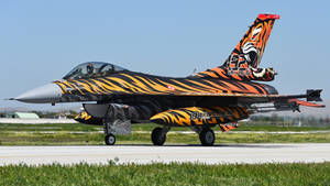 A High-velocity Military Jet Flying Through The Clear Blue Sky. Wallpaper