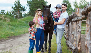 A Joyous Family Enjoying A Day At The Ranch Wallpaper