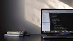 A Laptop Is On A Desk Wallpaper