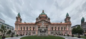 A Large Building With A Clock Tower In The Middle Wallpaper