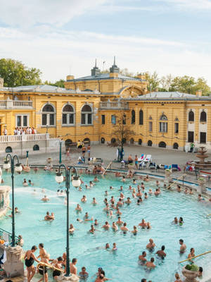 A Large Pool With People Swimming In It Wallpaper