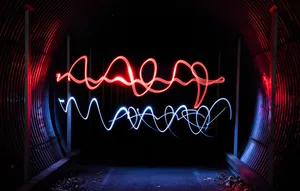 A Light Painting Of A Tunnel With Red And Blue Lights Wallpaper
