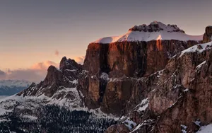 A Lone Man Stands On The Summit Of A Mountain Wallpaper