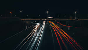 A Long Exposure Of A Highway At Night Wallpaper
