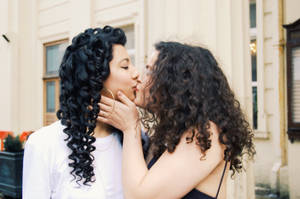 A Loving Moment Caught: Same-sex Couple Kissing In The Street Wallpaper