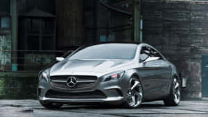 A Luxurious, Black Mercedes-benz Car Parked In An Open Lot. Wallpaper