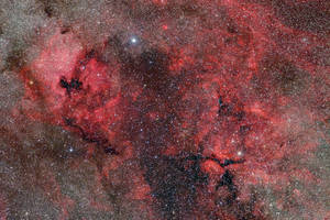 A Majestic View Of A Red Nebula In Space Wallpaper