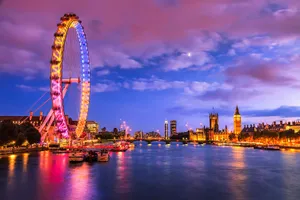 A Majestic View Of The London Eye Against An Azure Sky Wallpaper