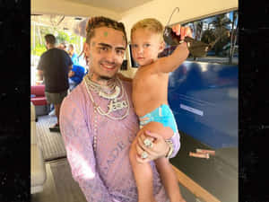 A Man Holding A Child In A Boat Wallpaper