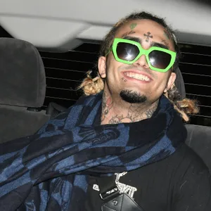 A Man In A Car With Sunglasses And A Scarf Wallpaper