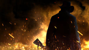 A Man In A Hat And A Hat Is Standing In Front Of Fire Wallpaper