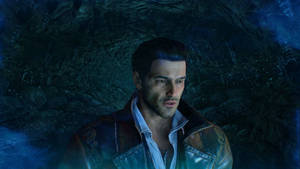 A Man In A Jacket Standing In A Cave Wallpaper