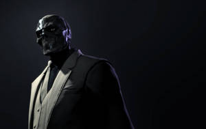 A Man In A Suit And Mask Standing In A Dark Room Wallpaper