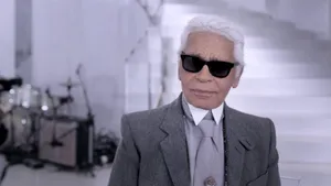 A Man In A Suit And Sunglasses Is Standing In Front Of A Stage Wallpaper