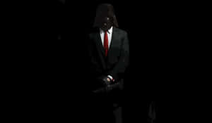 A Man In A Suit And Tie Is Holding A Gun Wallpaper