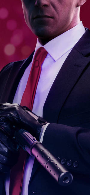 A Man In A Suit Holding A Gun Wallpaper