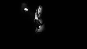 A Man In A Suit Is Standing In The Dark Wallpaper