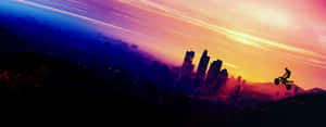 A Man Is Jumping Over A City At Sunset Wallpaper