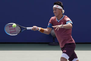 A Man Is Playing Tennis On A Court Wallpaper