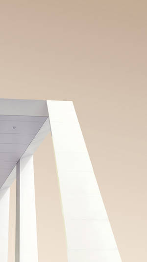 A Man Is Riding A Skateboard On A White Building Wallpaper