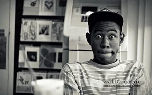 A Man Is Sitting In Front Of A Refrigerator Wallpaper