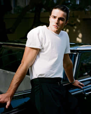 A Man Leaning Against A Car Wallpaper