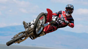 A Man Riding A Dirt Bike Wallpaper