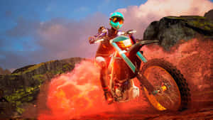 A Man Riding A Dirt Bike Through A Red Dust Wallpaper