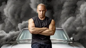 A Man Standing Next To A Car With Smoke Coming Out Of It Wallpaper
