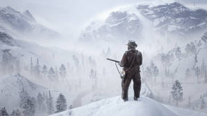 A Man Standing On Top Of A Snowy Mountain Wallpaper