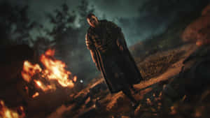 A Man Walking Through A Forest With Fire Wallpaper