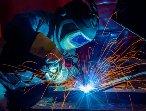 A Man Welding Metal Wallpaper
